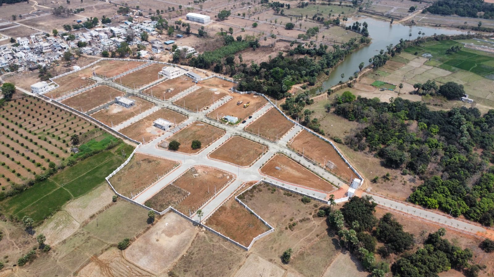 Aerial view of plotted venture beside lake